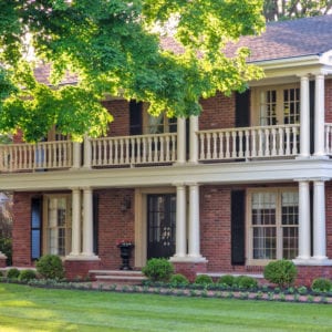 Beautiful front entry with Tuscan columns and railing