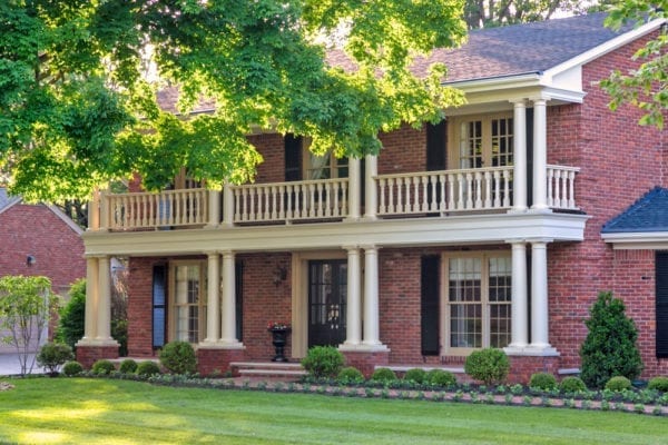 Beautiful front entry with Tuscan columns and railing