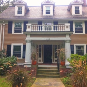 Covered front entry with upper balustrade