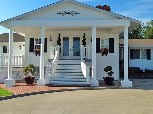 After porch addition. Curved stair rails