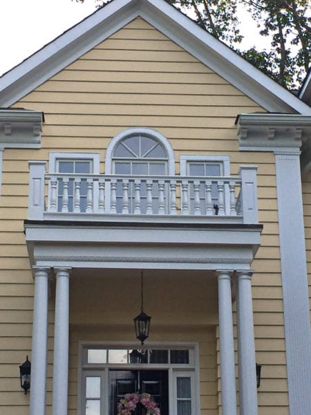 Covered entry with classic spindles and railing