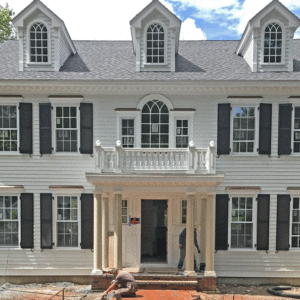 Federal style home with covered front entry and balustrades