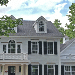 Federal style home with covered entry and balustrade