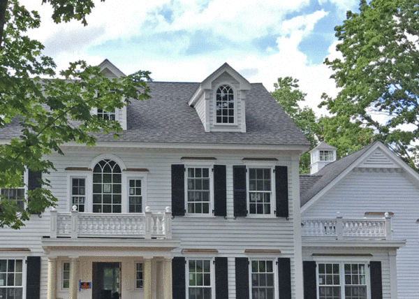 Federal style home with covered entry and balustrade