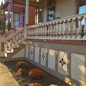 colorful front porch railing with big spindles and railings