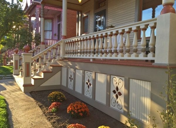 colorful front porch railing with big spindles and railings