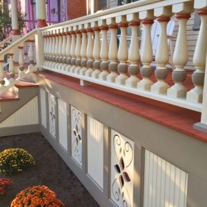 Front porch with large porch spindles and railing