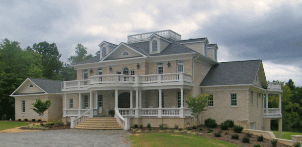 Large custom home with porch railing and widows walk