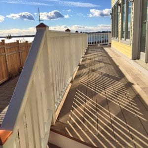 Deck railing with square balusters and sloped bottom rail