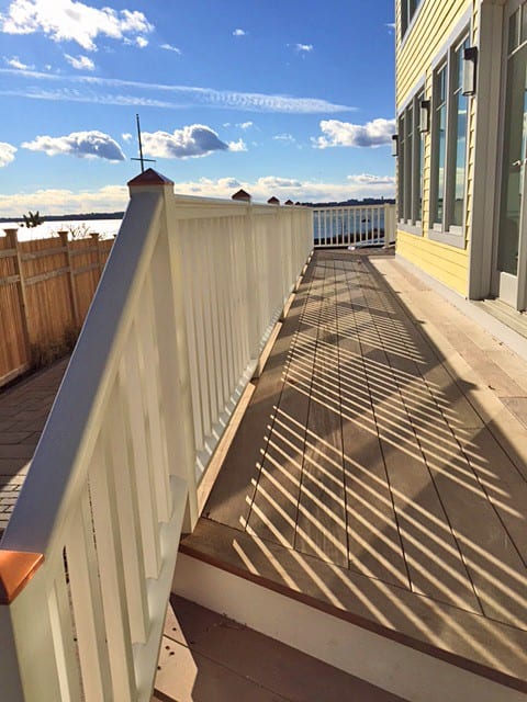 Deck railing with square balusters and sloped bottom rail